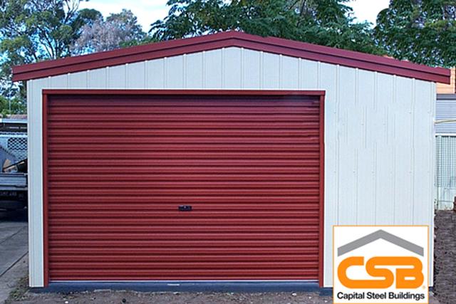 A white building with a red roof and roller door